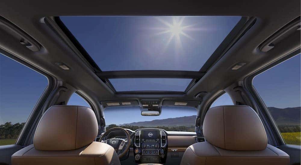 The interior of a 2021 Nissan Titan shows the panoramic moonroof view.