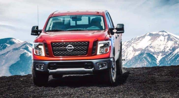 A red 2018 Nissan Titan is shown from the front parked in the mountains after leaving a Nashville used Nissan dealership.