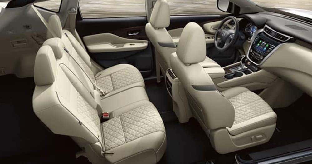 The tan interior of a 2020 Nissan Murano shows two rows of seating.