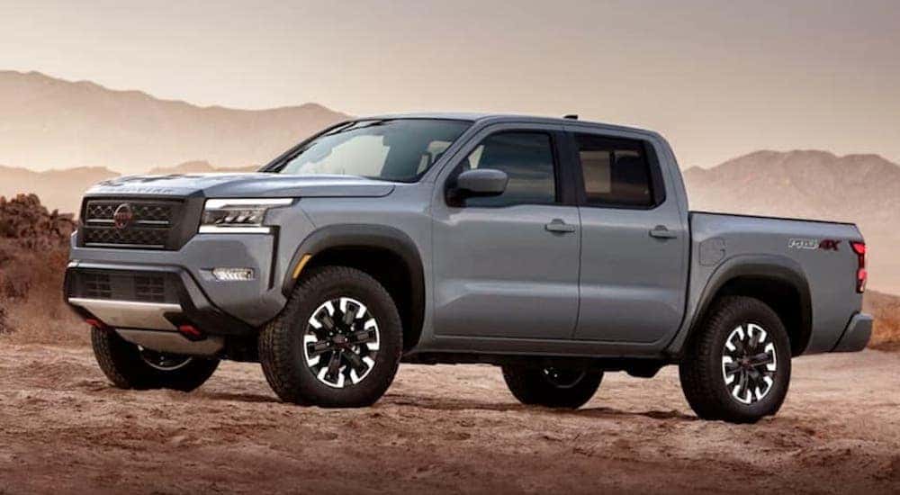 A grey 2022 Nissan Frontier Pro-4x is shown from the side while parked in sand.