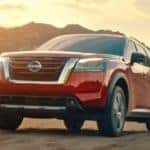 A red 2022 Nissan Pathfinder is shown from the front at an angle while off-road after leaving a Lynchburg Nissan dealer.