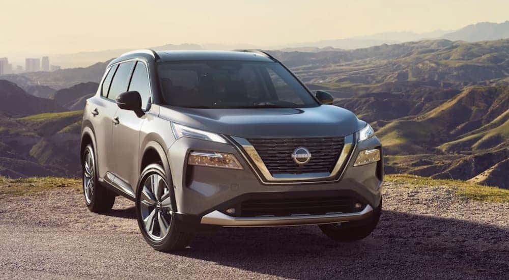 A grey 2022 Nissan Rogue is shown from the front parked in the mountains after leaving a Nissan SUV dealer.