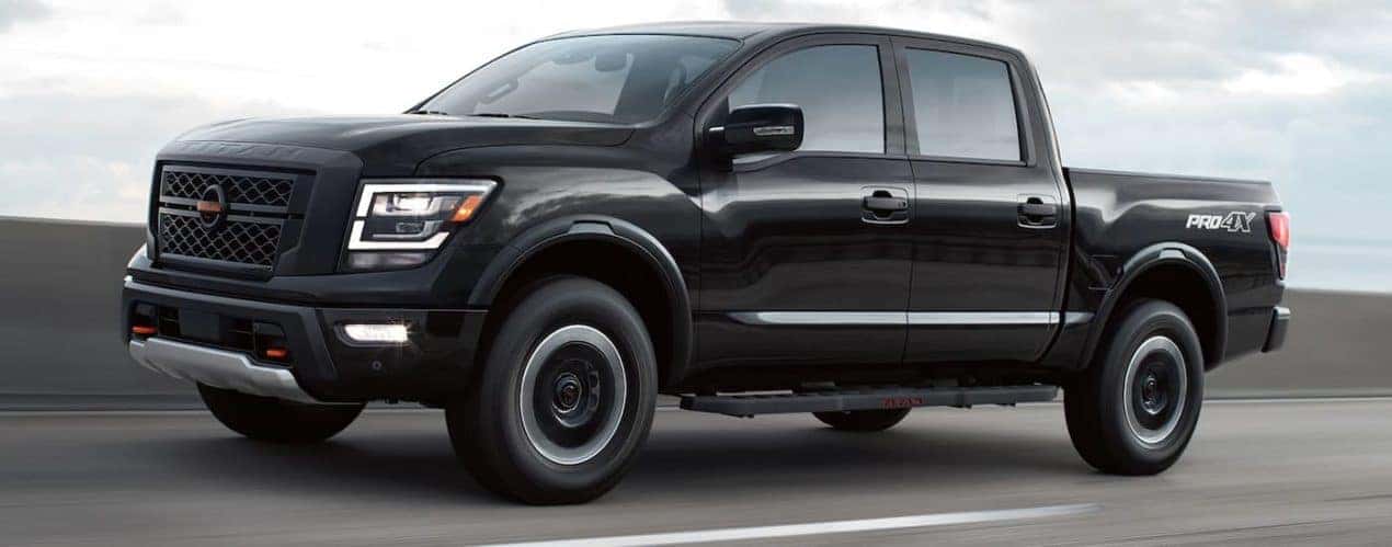 A black 2022 Nissan Titan Pro-4x is shown driving on a highway.