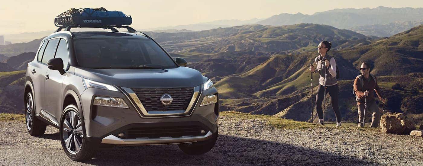 A grey 2022 Nissan Rogue is shown parked in front of a mountain range after leaving a Nissan Rogue Hendersonville dealer. 