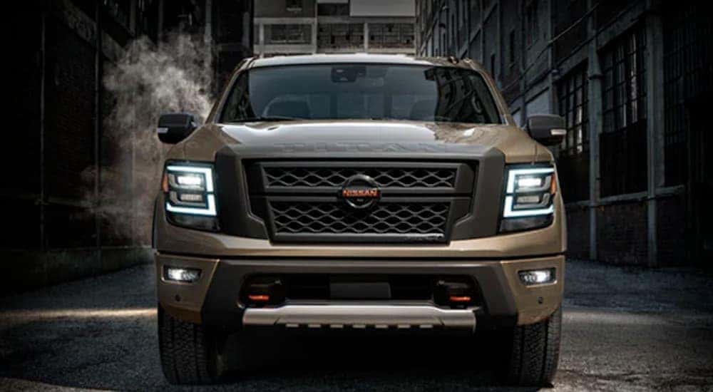 Front view of a brown 2021 Nissan Titan parked in an industrial area