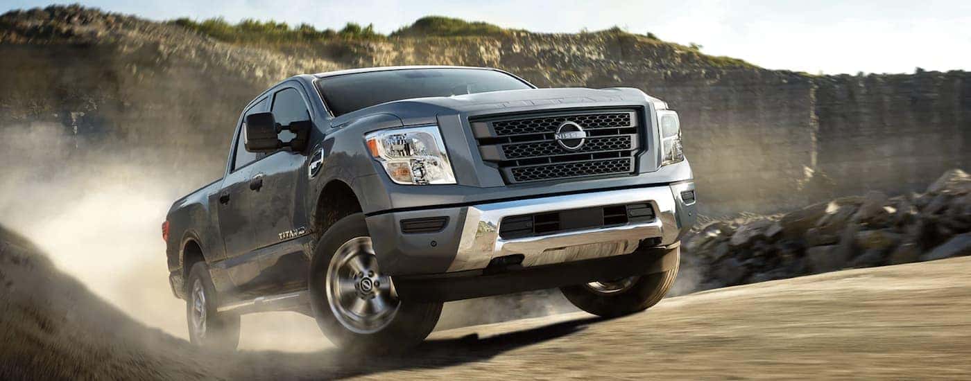 A grey 2022 Nissan Titan is shown off-roading after leaving a certified Nissan Titan dealer.