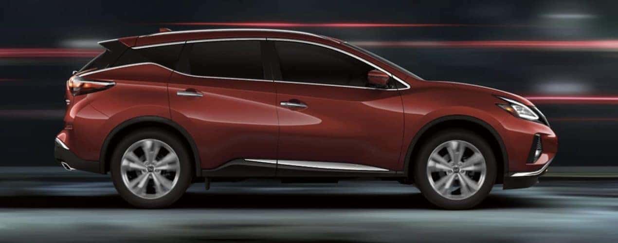 A maroon 2023 Nissan Murano is shown from the side driving through a tunnel.