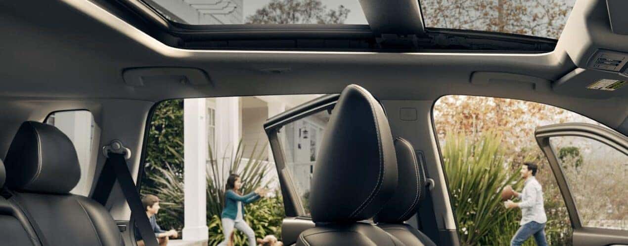The headrests in a 2023 Nissan Rogue are shown while parked in a driveway.