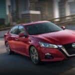 A red 2021 Nissan Altima is shown from the front at an angle.