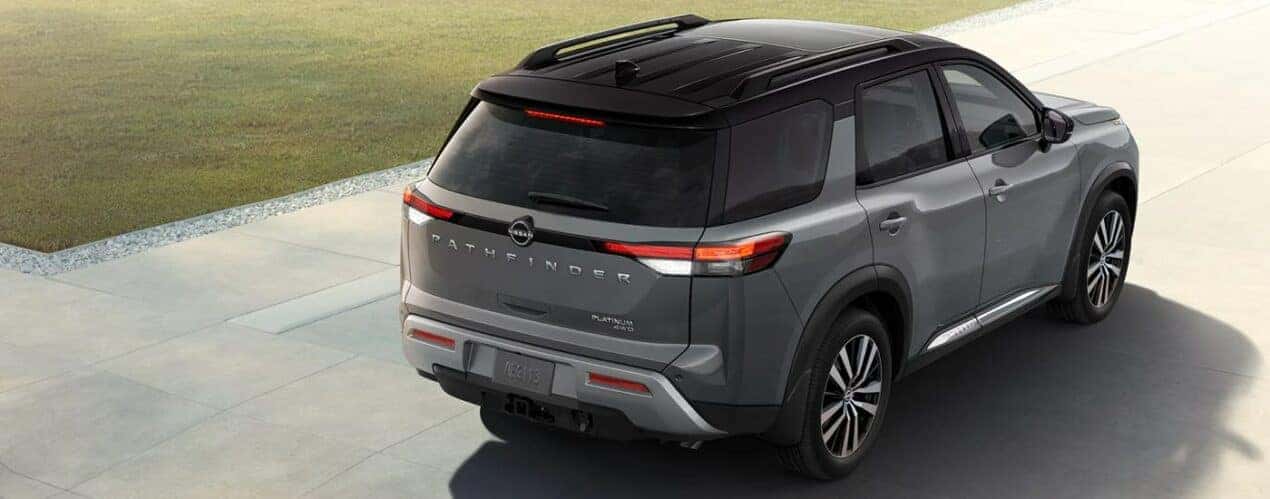 A grey 2023 Nissan Pathfinder Platinum is shown from the rear during a 2023 Nissan Pathfinder vs 2023 Toyota Highlander comparison.