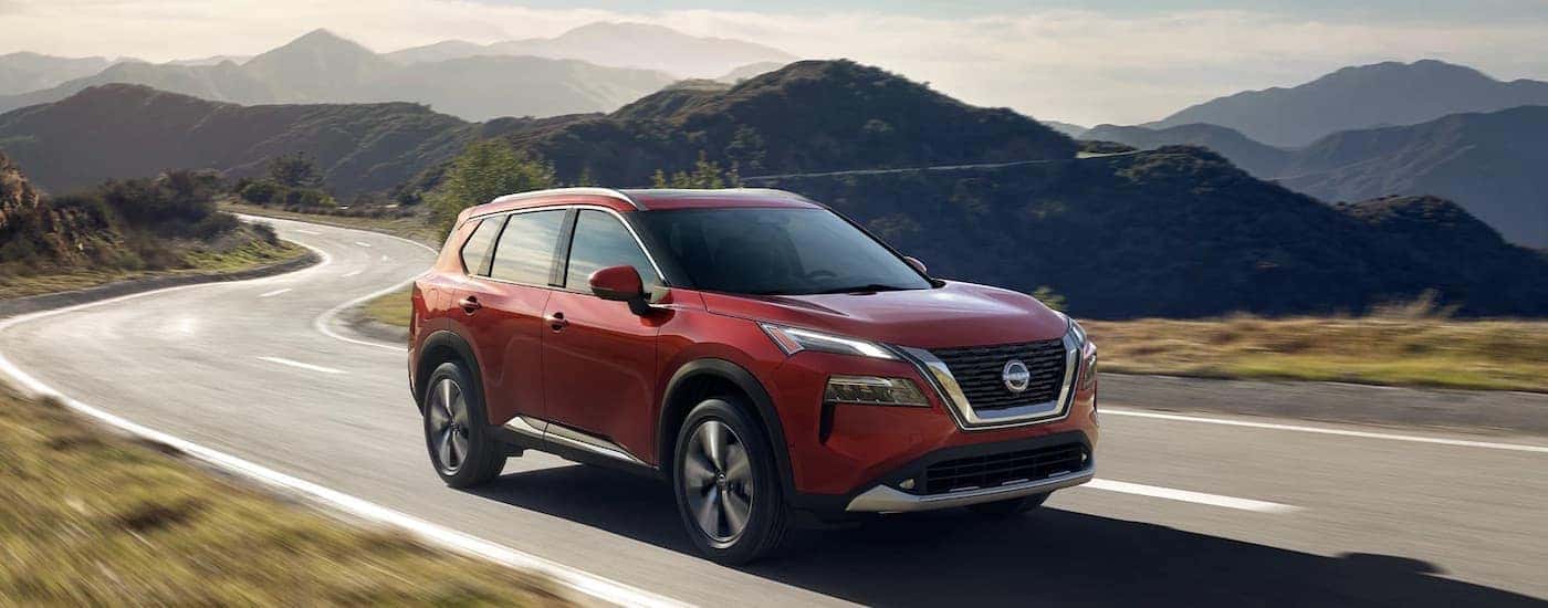 A red 2023 Nissan Rogue is shown from the front at an angle.