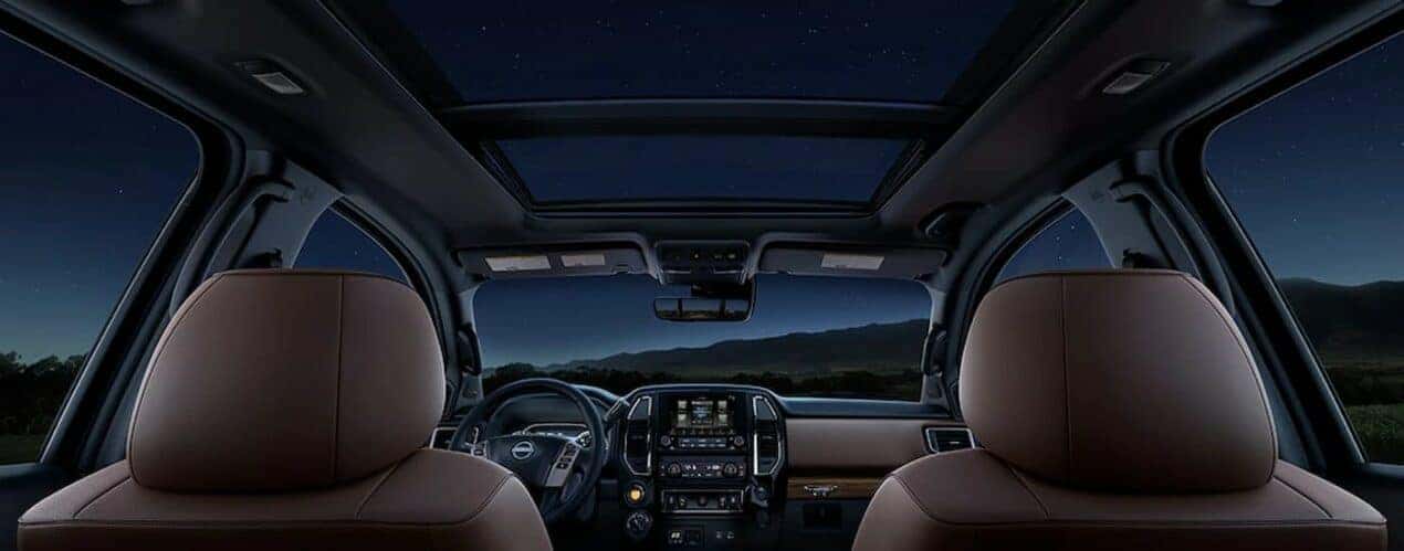 The black and brown interior and dash of a 2024 Nissan Titan is shown.
