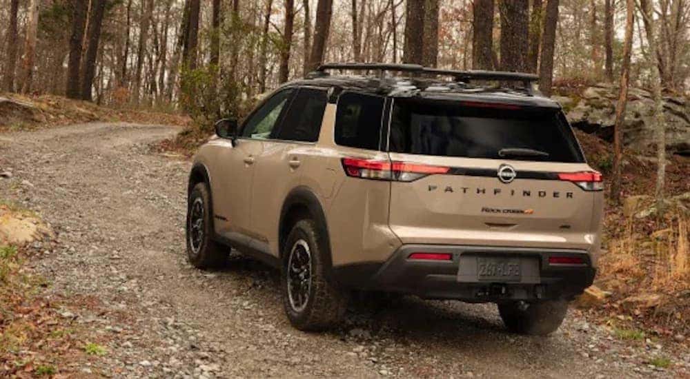 A brown 2023 Nissan Pathfinder is shown from the rear at an angle.