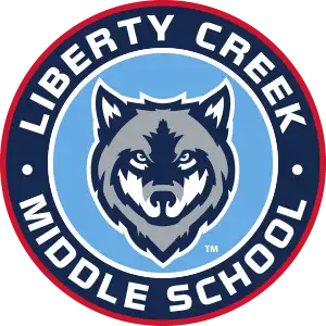 Liberty Creek Middle School logo with Wolf on blue background