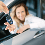 woman sitting in car reaching for keys