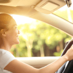 Woman driving a car and smiling