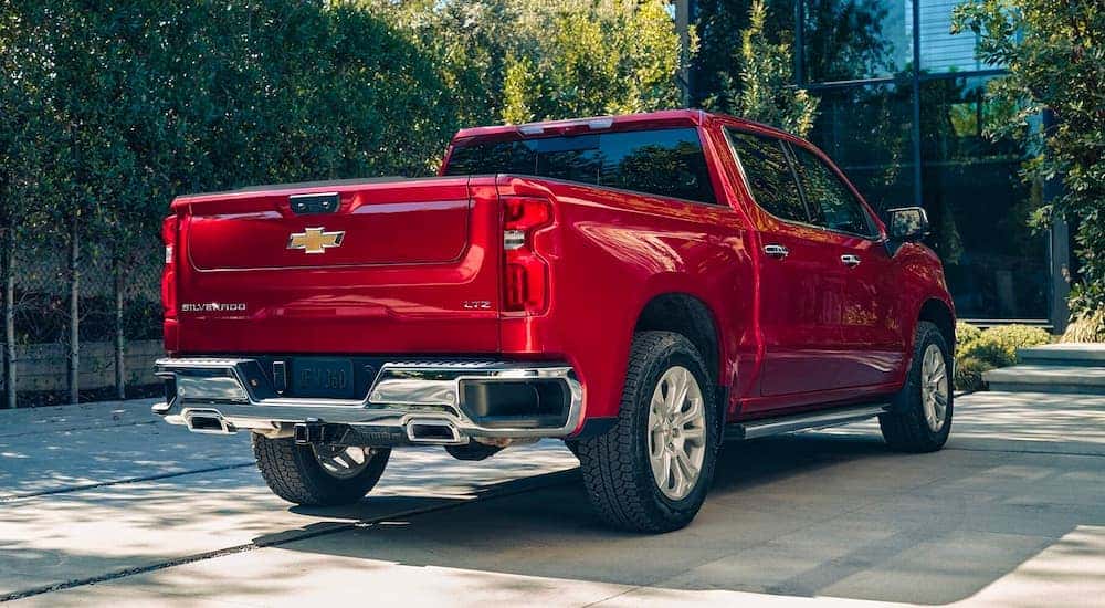 A red 2023 Chevy Silverado 1500 LTZ is shown from the rear parked on a driveway.