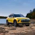 A yellow 2024 Chevy Trailblazer Activ is shown from the front at an angle after leaving a dealer that has a Chevy Trailblazer for sale.
