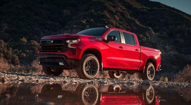 A red 2022 Chevy Silverado 1500 Z71 Trail Boss is shown from the side while off-road.