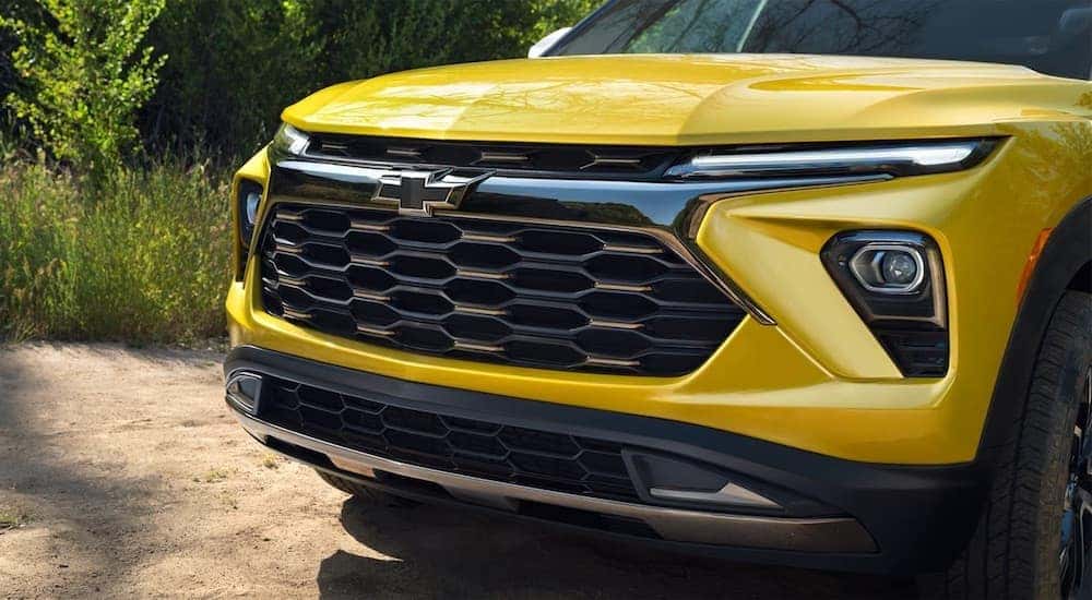 A close-up on the grille of a yellow 2024 Chevy Trailblazer ACTIV is shown.