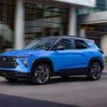 A blue 2024 Chevy Trailblazer EXT is shown driving from a Chevy dealer near Claiborne.