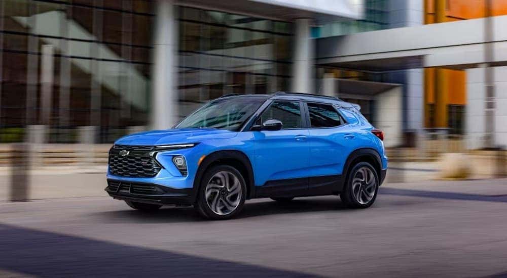 A blue 2024 Chevy Trailblazer EXT is shown driving from a Chevy dealer near Claiborne.