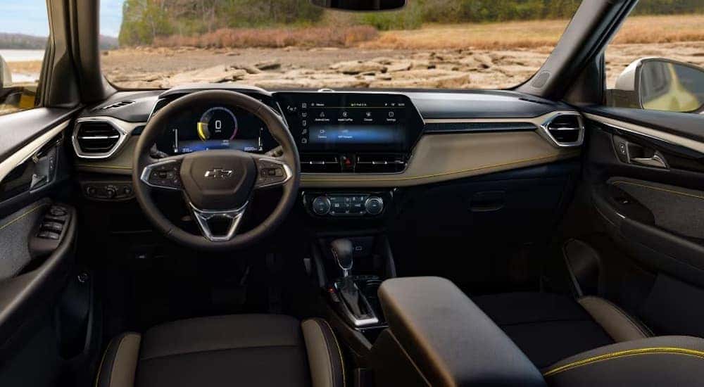 The black interior of a 2024 Chevy Trailblazer is shown from the driver's seat.