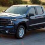 A black 2020 Chevy Silverado 1500 RST is shown driving on a highway after viewing a used Chevy Silverado for sale near Farmerville.