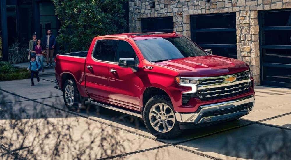 A red 2023 Chevy Silverado 1500 Z71 is shown parked on a driveway.