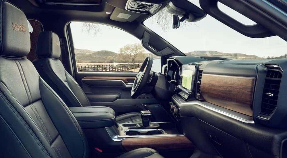 The black and brown interior and dash in a 2024 Chevy Silverado High Country is shown.