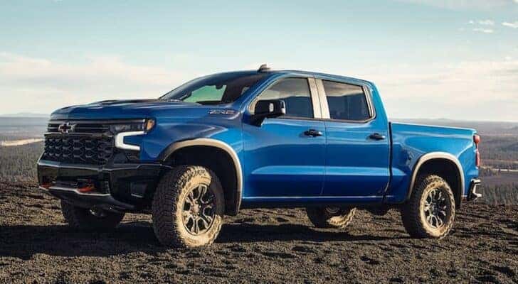 A blue 2022 Chevy Silverado 1500 ZR2 is parked on an off-road area.