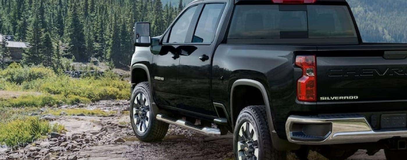 A black 2022 Chevy Silverado 2500HD is overlooking a mountain view.