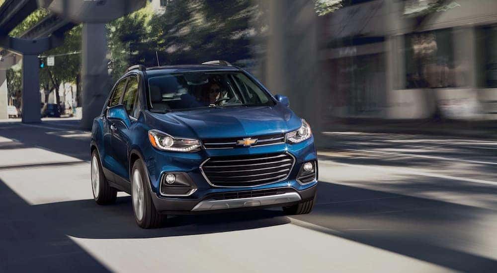 A blue 2020 Chevy Trax is shown driving to a used Chevy dealer near Arcadia.