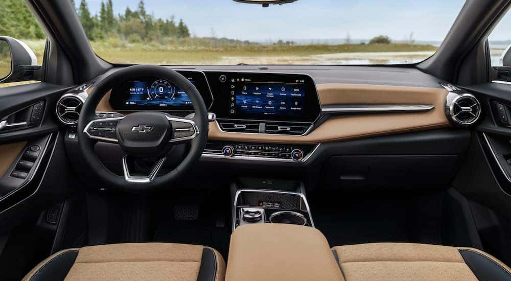 The tan interior of a 2025 Chevy Equinox ACTIV is shown from the center console.