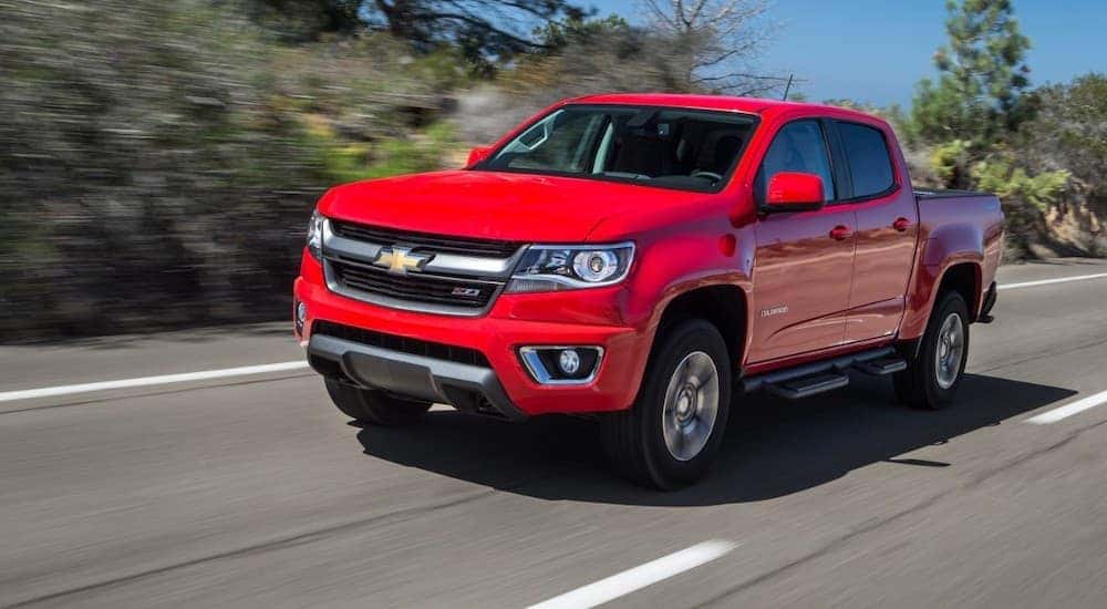 A red 2015 Chevy Colorado Z71 is shown driving on a highway after viewing a used Chevy Colorado for sale.
