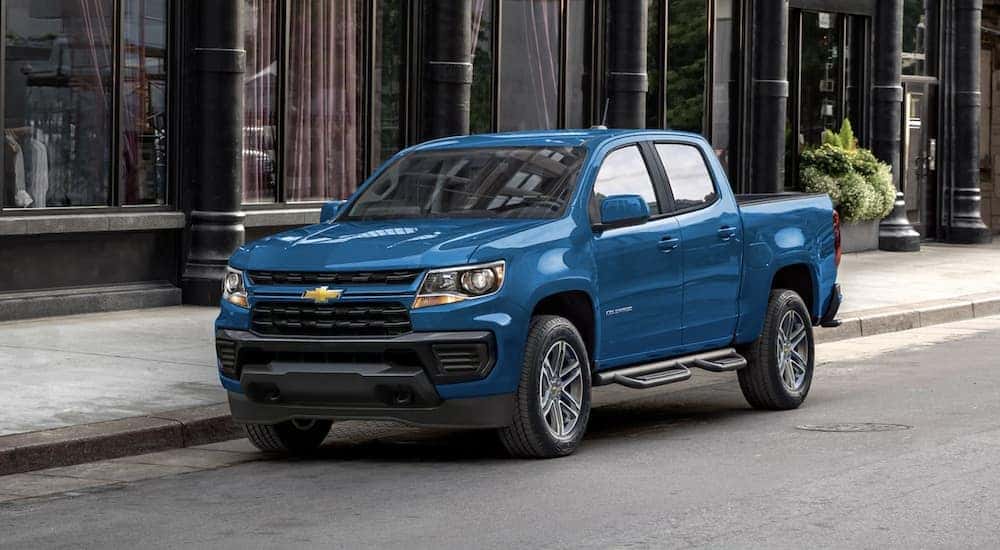 A blue 2022 Chevy Colorado is shown parked on a city street.