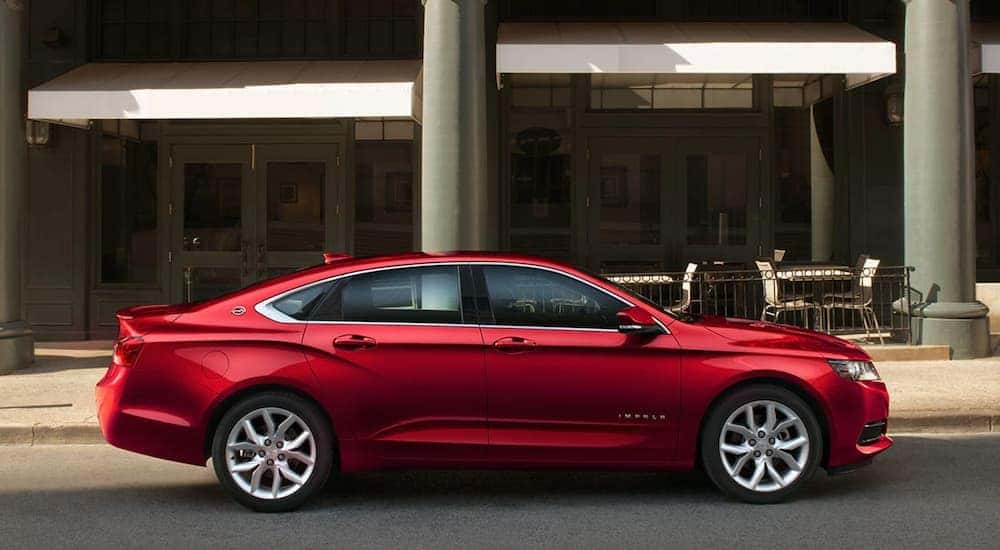 A red 2019 Chevy Impala is shown parked on a city street.