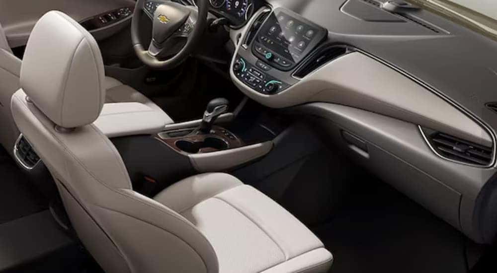 The white and gray interior and dash are shown in a 2023 Chevy Malibu.
