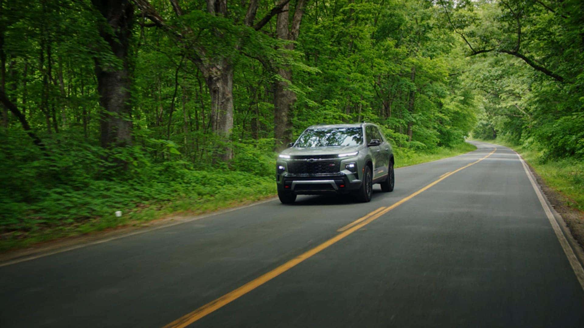 2025-Chevrolet-Traverse-Driving-Through-Forest-Road
