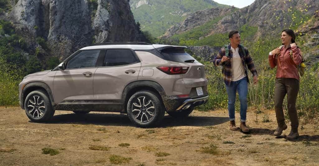 Two people hiking next to 2026 Trailblazer