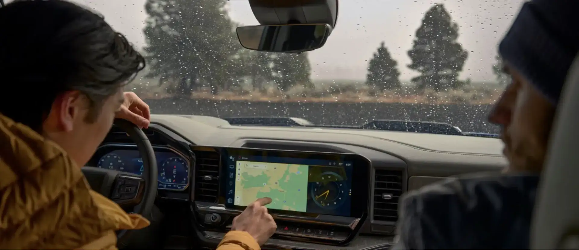 Driver using the navigation map on the 13.4-inch touch-screen display in a Chevy Silverado
