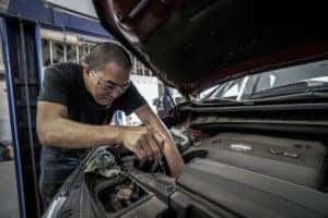 mechanic working in a cars engine bay