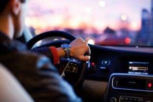 person driving a car with a watch