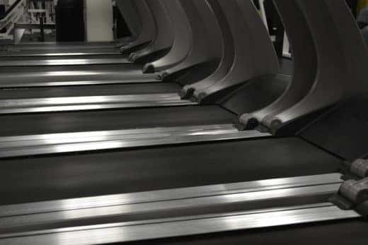 running surfaces of treadmills in a row