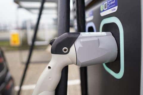 an ev charger plug at a charging station