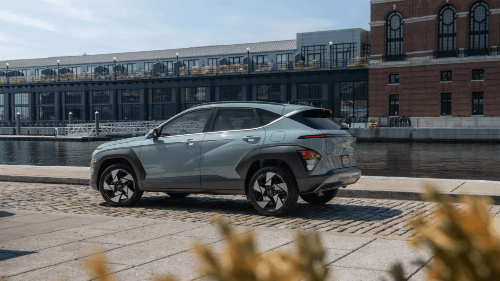 2026 Hyundai Kona parked on a brick road, next to a body of water