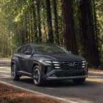2026 Hyundai Tucson driving on a scenic forest road