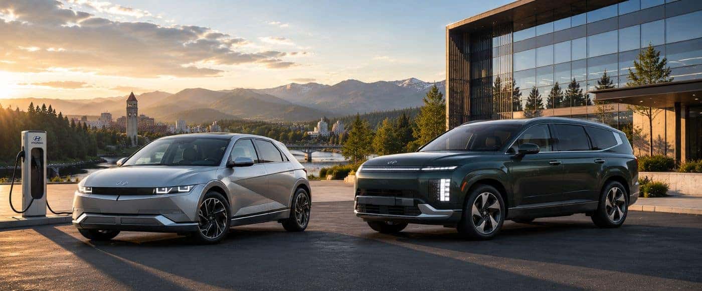 2026 Hyundai IONIQ 5 and Hyundai IONIQ 9 electric vehicles overlooking Spokane River and downtown Spokane at sunset