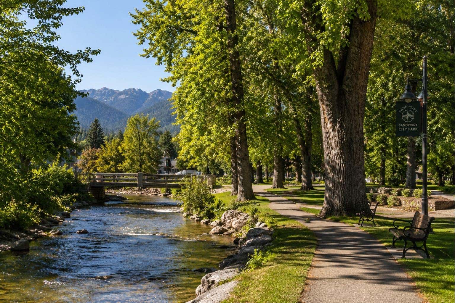 Sandpoint City Park riverside view with mature trees
