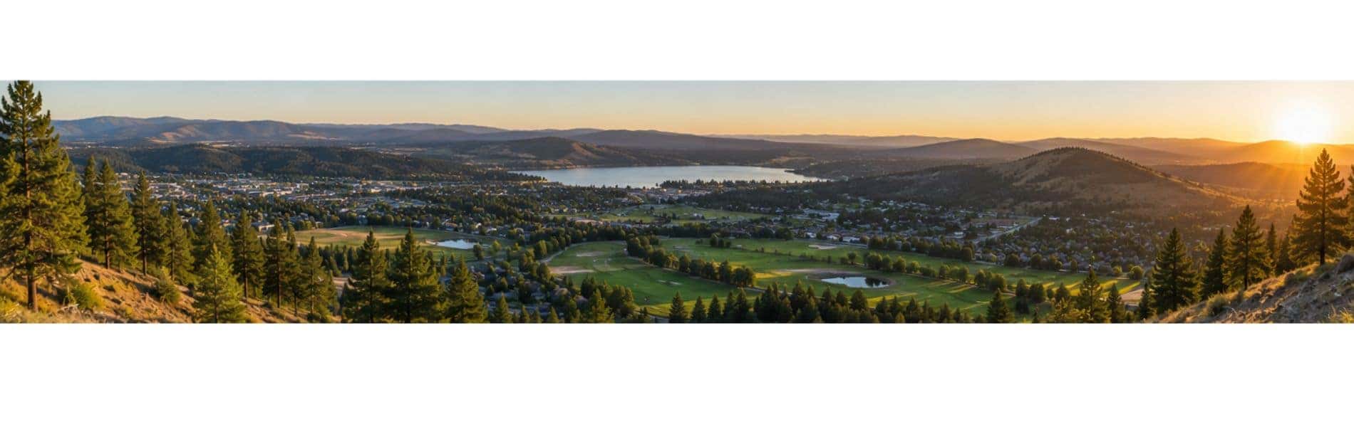 Sunset overlook above Liberty Lake with forested hills, MeadowWood Golf Course, and the surrounding valley